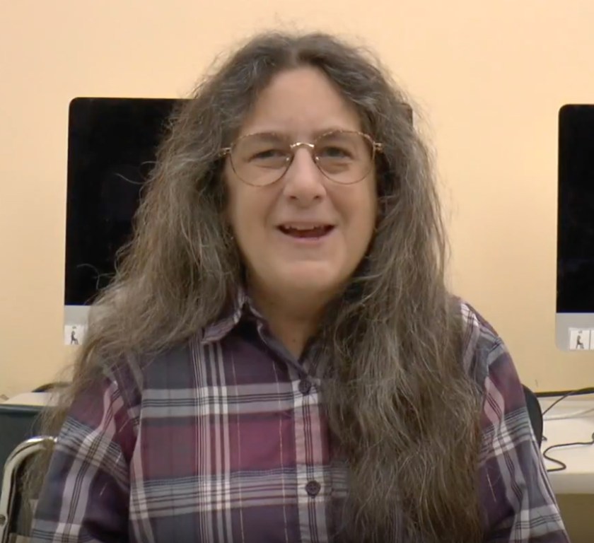 Jeanne Stork is in the computer lab. Small sections of computers are behind here.