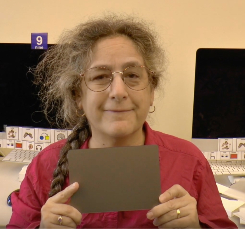 Jeanne Stork is holding a trackpad.
